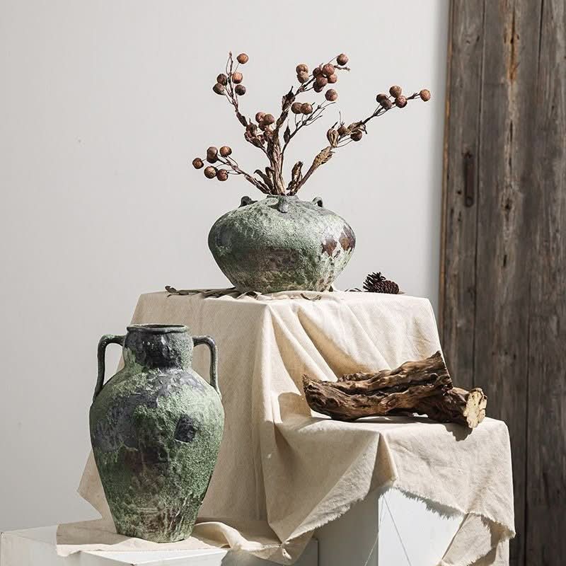 Wabi-Sabi distressed vases in gray tones, with dried branches and driftwood, home decor.