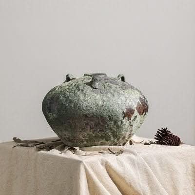 Wabi-Sabi Distressed Vase in gray tones, textured ceramic with handles, sits on draped linen.