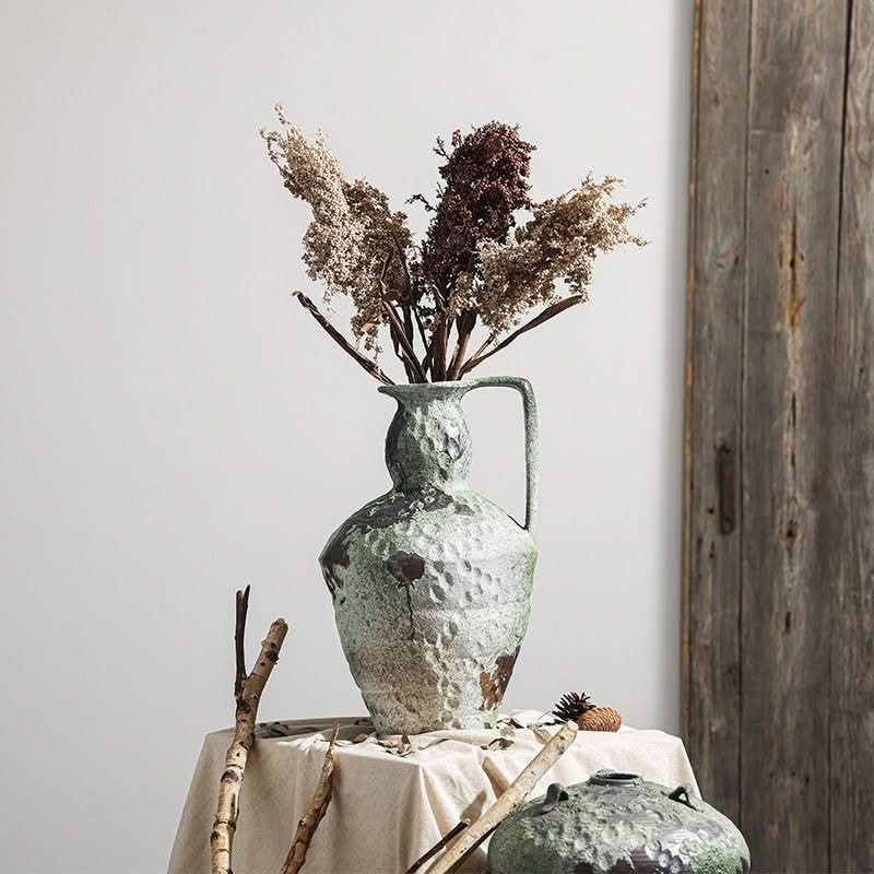 Wabi-Sabi Distressed Vases in gray tones, with dried flowers on a textured ceramic surface.