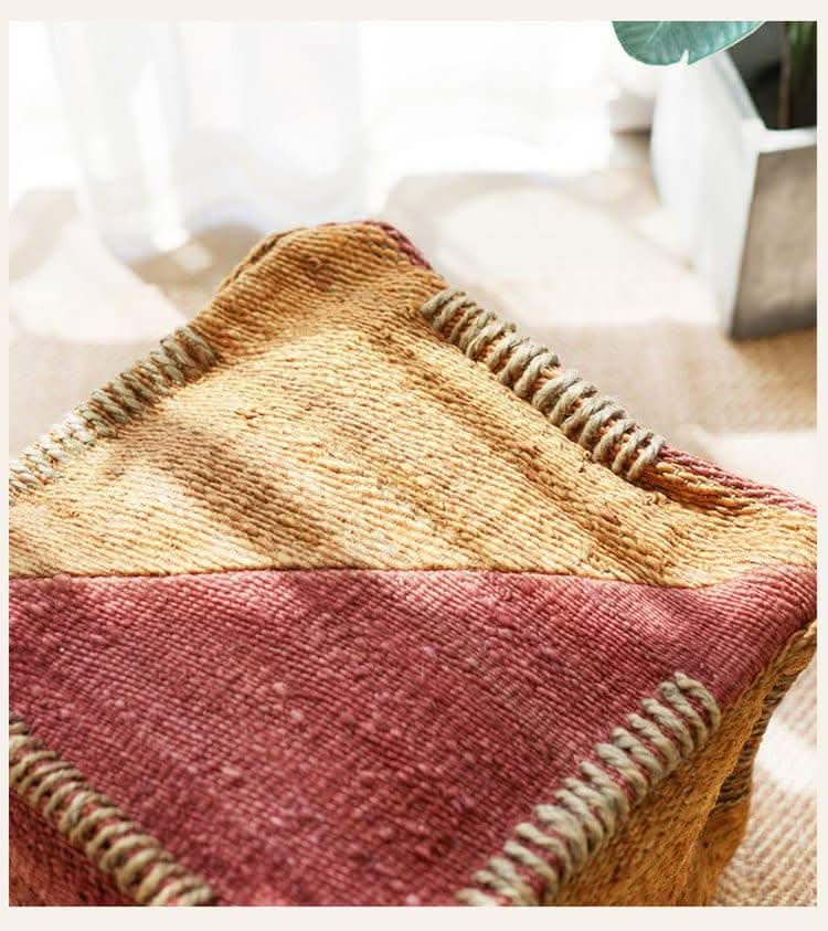 Wabi-sabi jute ottoman footstool in earthy tones with textured jute weave.