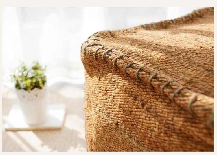 Wabi-sabi jute ottoman footstool, natural brown woven texture with visible stitching.