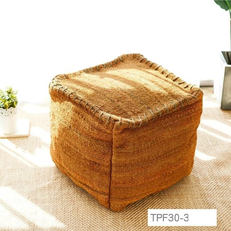 Wabi-sabi jute ottoman footstool in natural brown, handmade with textured stitching on carpet.