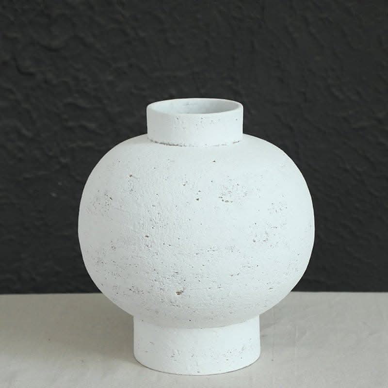 Wabi-sabi white clay pot, round with tight opening, home decor accent on textured background.
