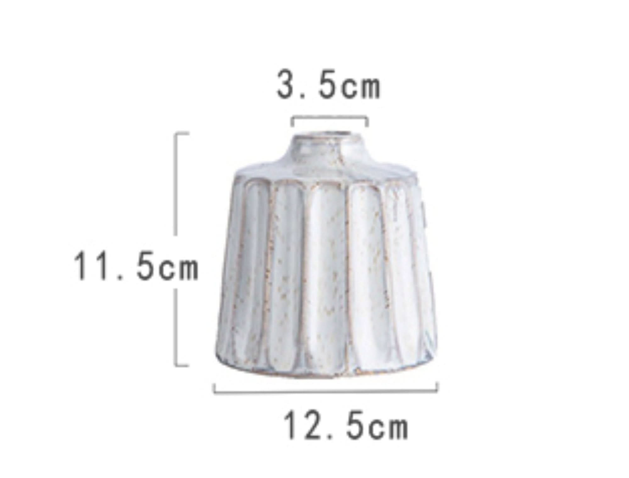 White ceramic small vase with ribbed texture, home decor accent.