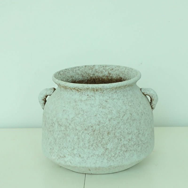 Textured white clay pot with handles for plants, home decor.