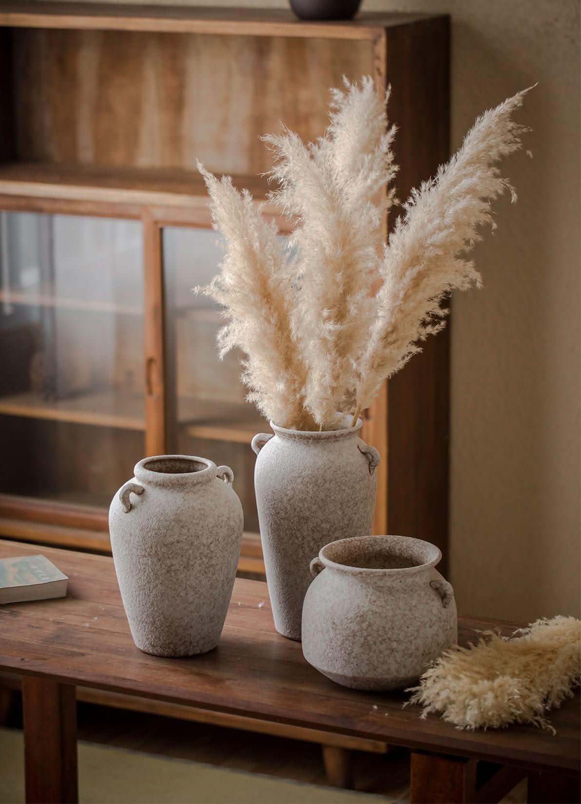 Textured white clay pots with handles, perfect for home decor and plants.