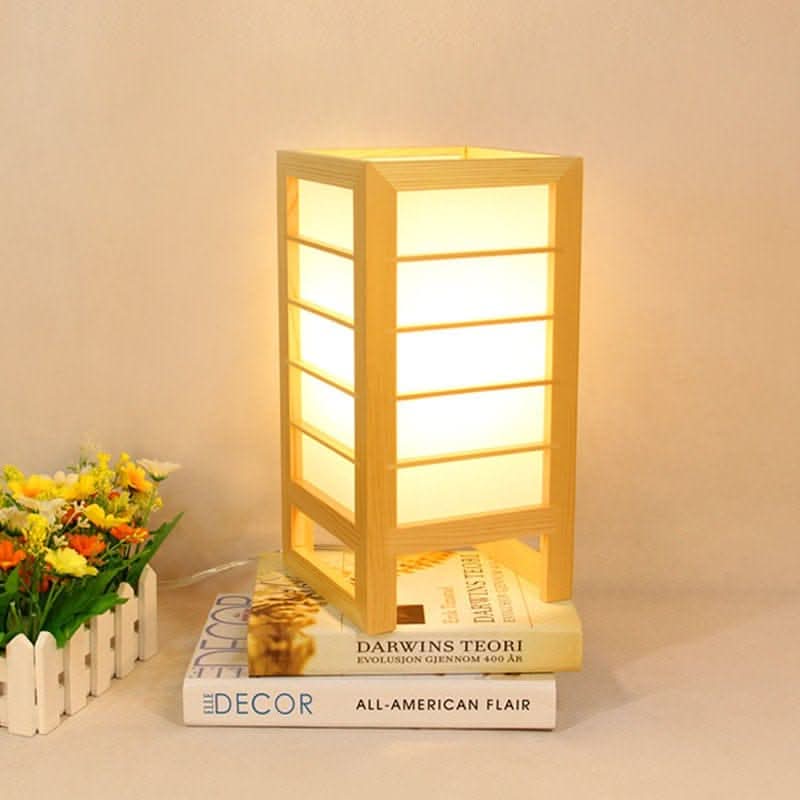Wooden Shoji Bedside Lamp, mid-century style, on books with flowers.